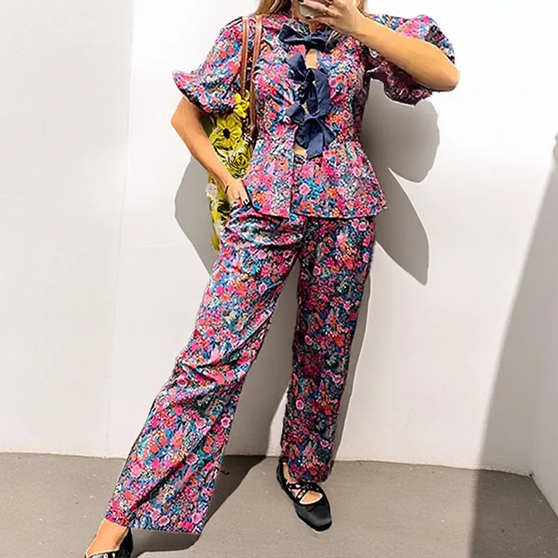 Women's floral print trousers suit with puff sleeves and tie-neck design in picture colour
