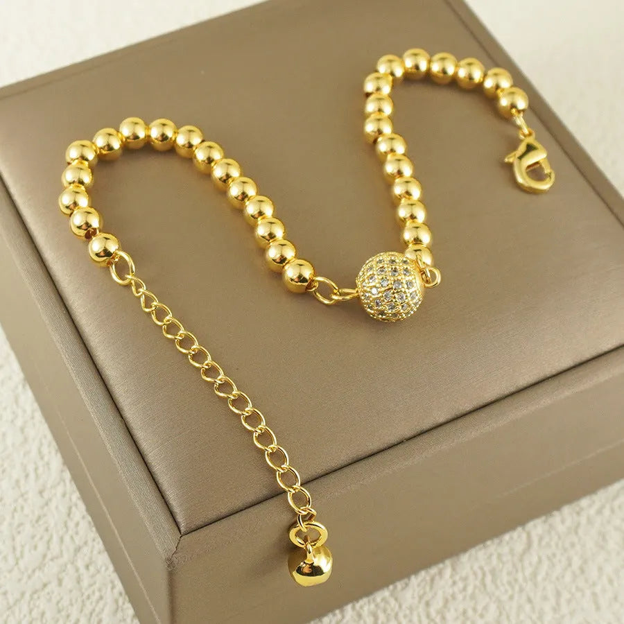 Arabic-style women's copper bracelet with a heart-shaped zircon ornament on a model's wrist.