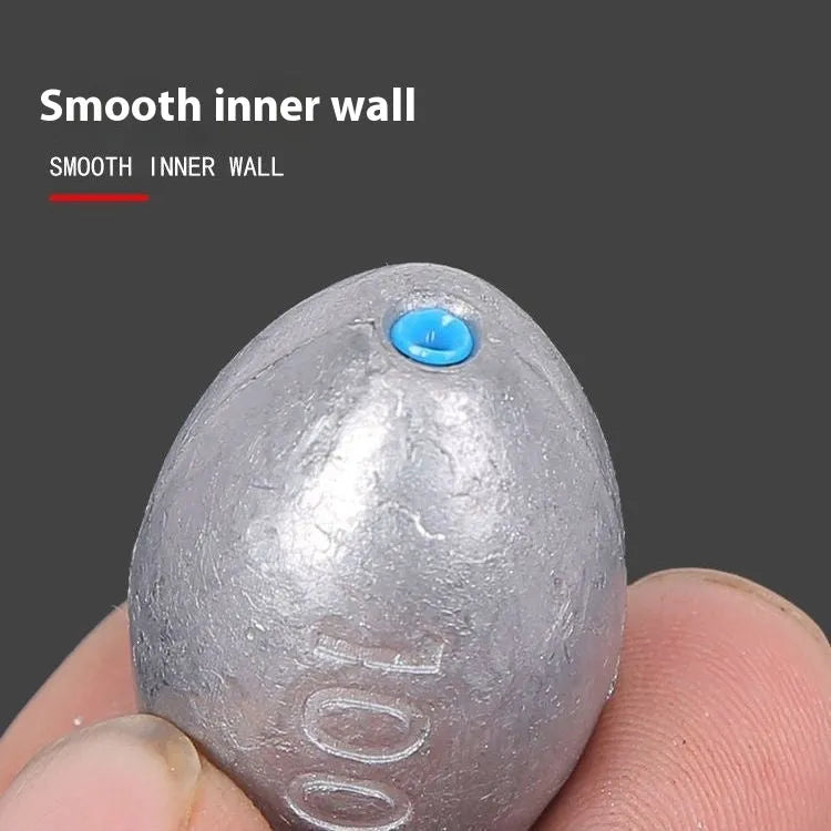 Olive-coloured rugby-shaped sea fishing sinker with a textured scale pattern, showing weight markings.