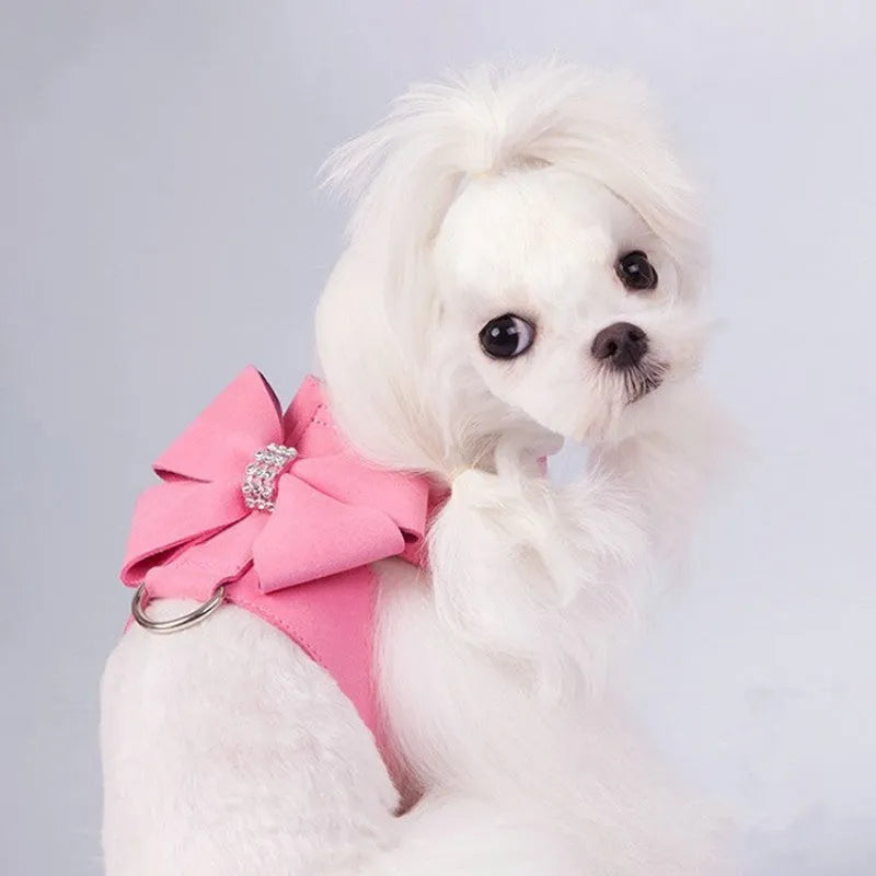 Pink microfiber puppy chest strap with a bowknot, showing the D-ring leash clip.