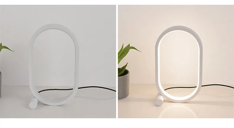 USB plug-in oval acrylic touch dimmable night light with metal base on a desk, black colour