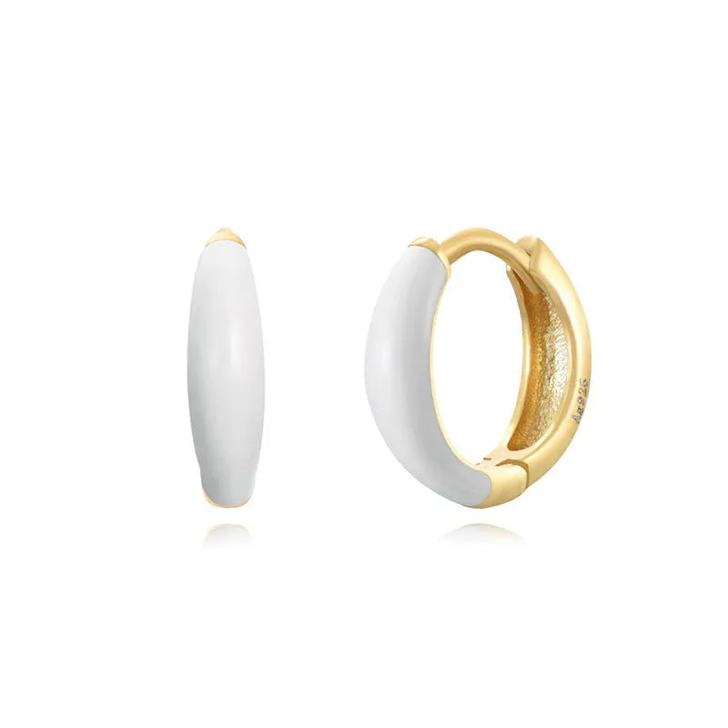 A pair of oval-shaped, U-curved epoxy earrings in a solid colour on a plain background.