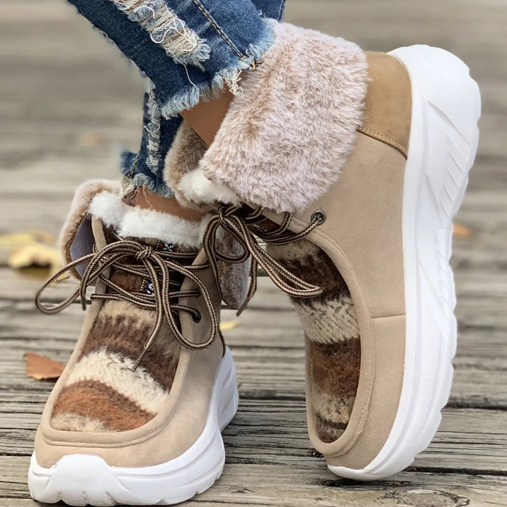 Women's beige lace-up suede snow boots with a thick rubber sole and plush lining, shown from the side.