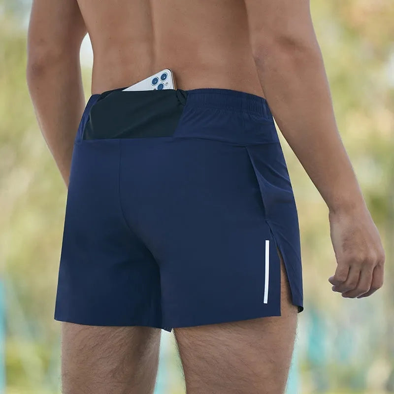 Man wearing red high-waisted loose-fit off-road running shorts during a cross-country run.