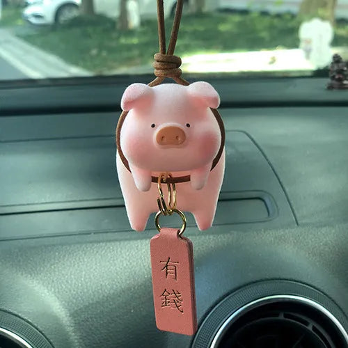 A cute cartoon pig resin figurine car decoration accessory on a dashboard.