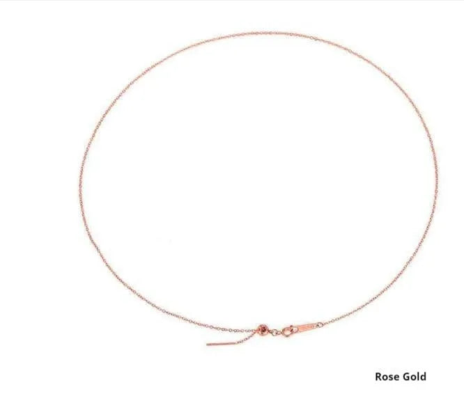 Stainless steel necklace with a U-shaped pendant on a chain, shown in steel, gold, and rose gold colour options.
