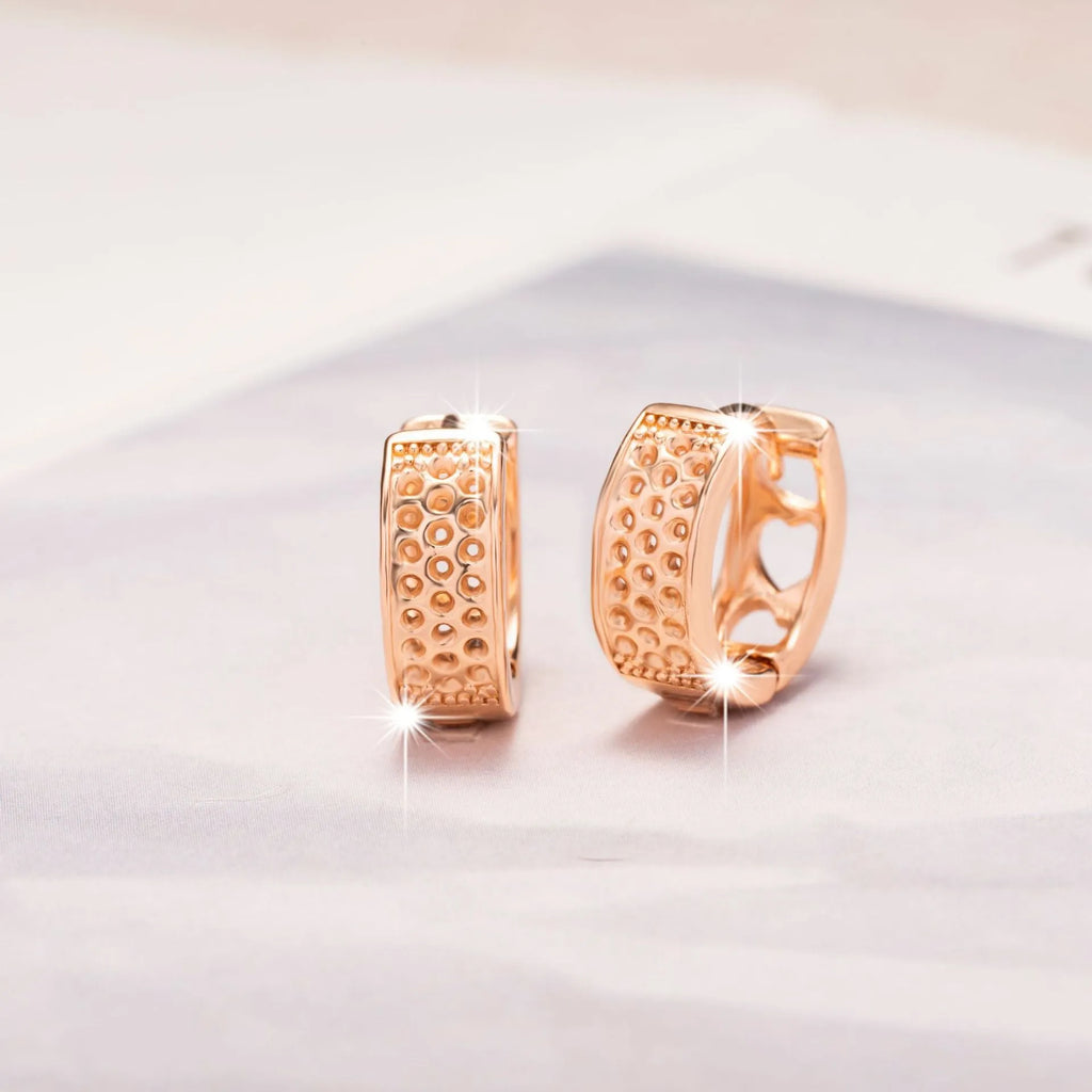 Rose gold women's earrings with three hollowed-out hearts in a circular, sweet style.