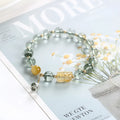 Green phantom quartz crystal bracelet with rutilated inclusions, geometric ethnic design, 8mm diameter