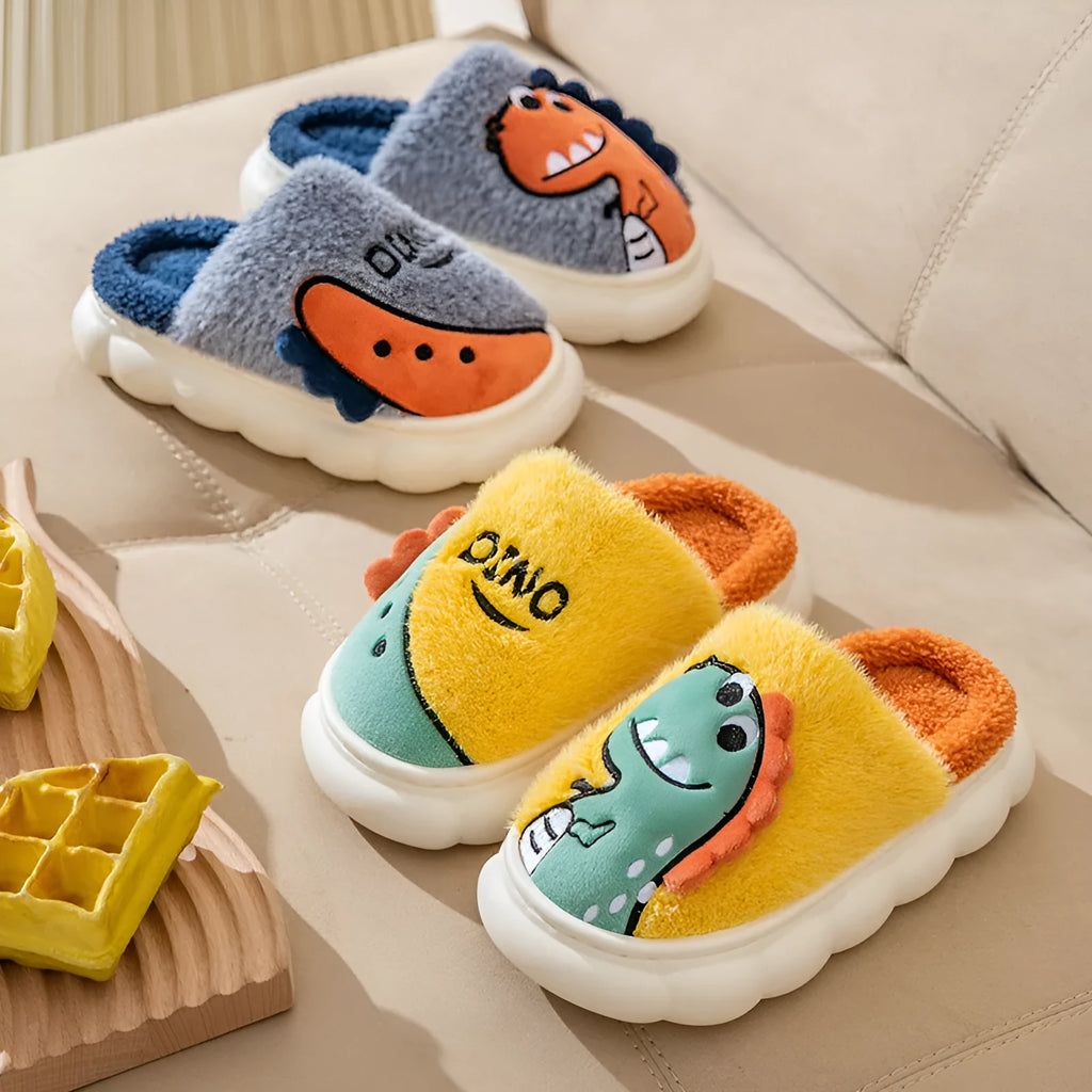 A pair of thick plush couple slippers with dinosaur graphics in coffee, grey, or orange colours.