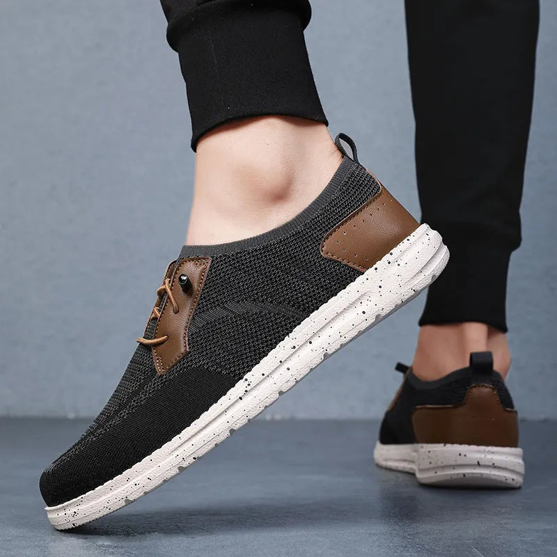 Men's black laceless canvas slip-on casual shoes with a round toe and rubber sole.