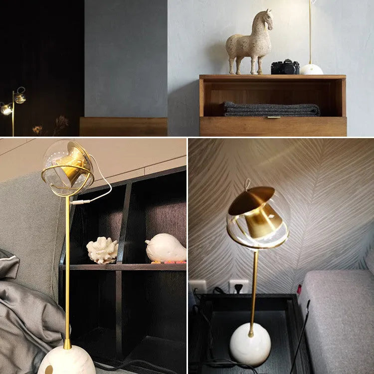 Dimmable touch-controlled desk lamp with glass shade on wooden desk