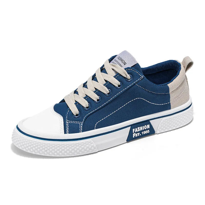 Men's blue low-top canvas casual sneakers with round toe and lace-up front on a white background.