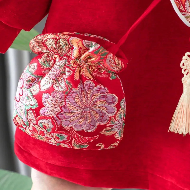 Girls winter velvet padded dress in retro red solid colour with long sleeves, front view on child