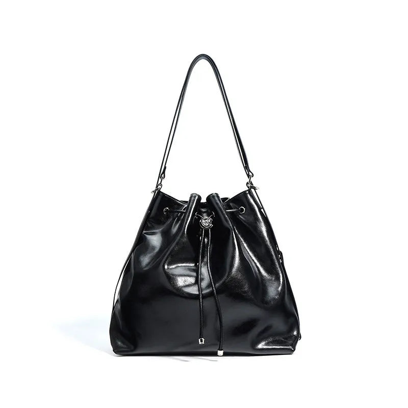 Genuine leather women's bucket bag with one shoulder strap in a retro style.