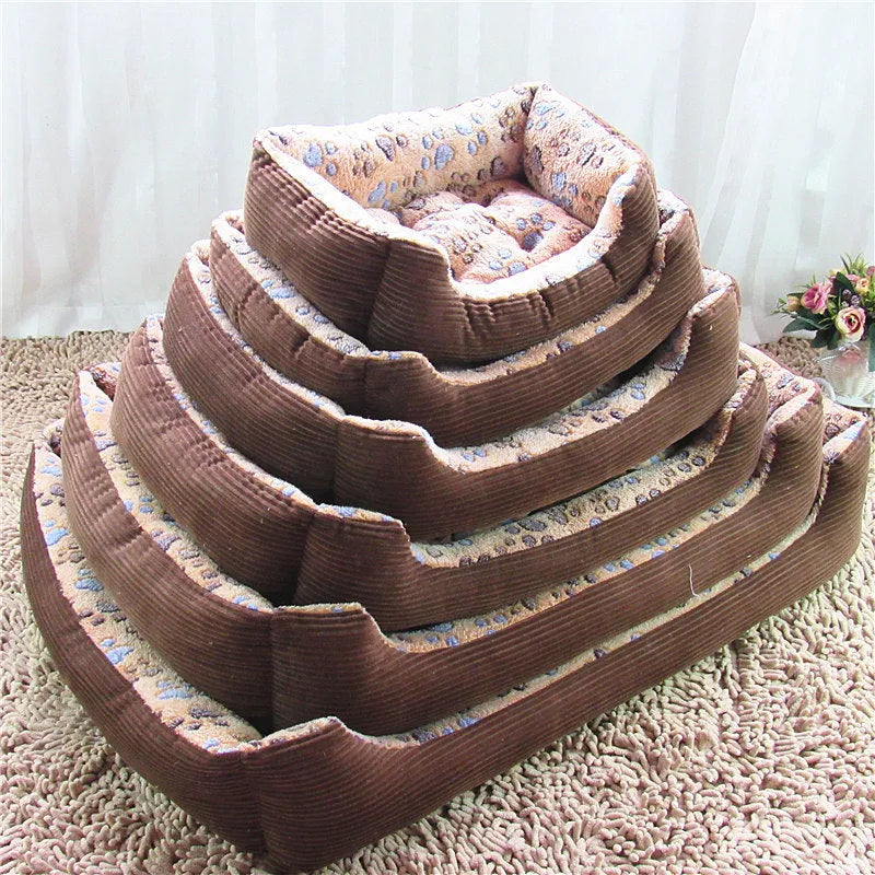 Beige sofa-style plush pet bed for small dogs with raised basket edges on a wooden floor.