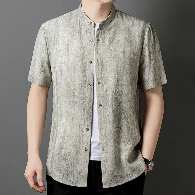 Man wearing a grey loose-fit linen blend cardigan shirt with a stand collar.