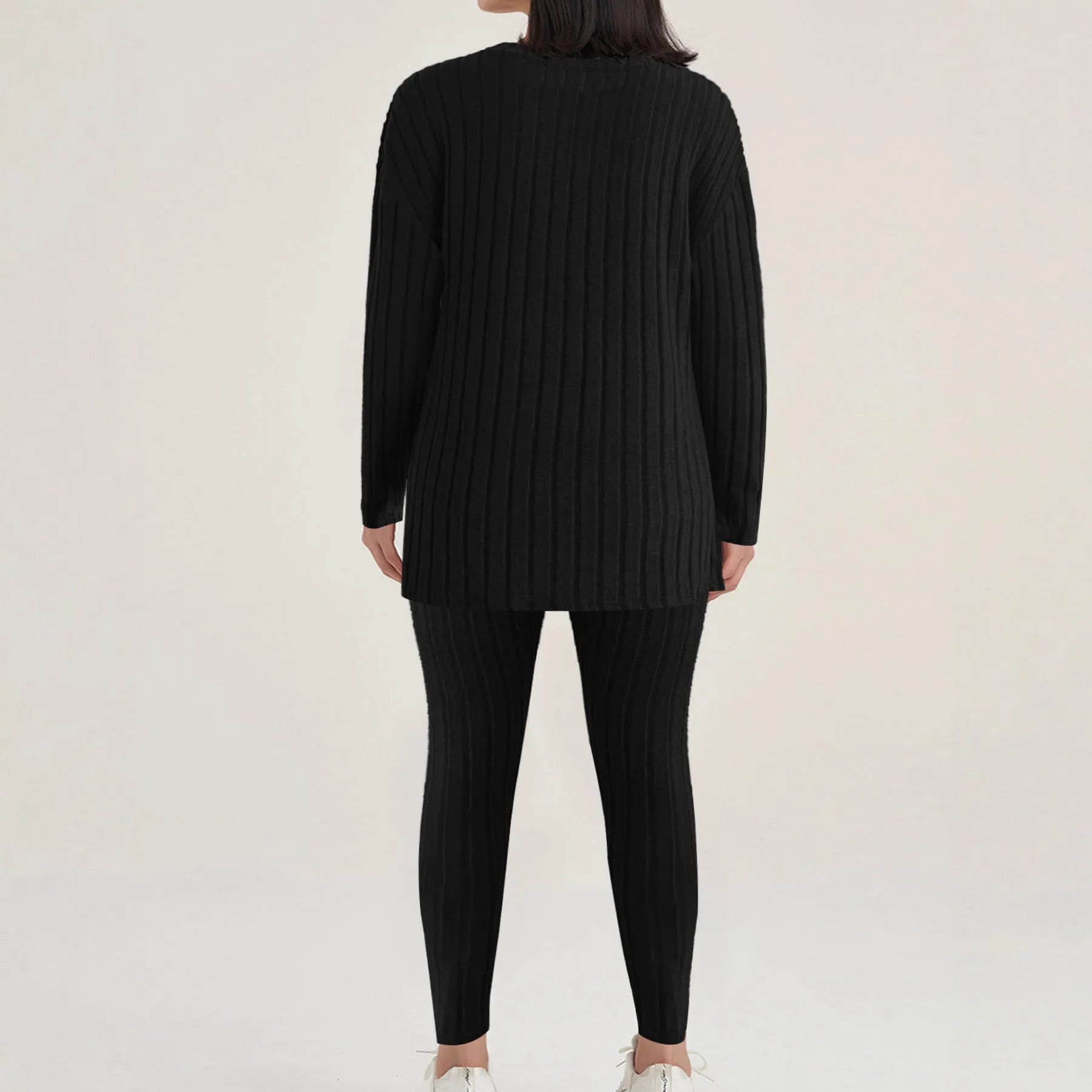 Black sunken stripe two-piece loungewear set with top and trousers on a hanger.