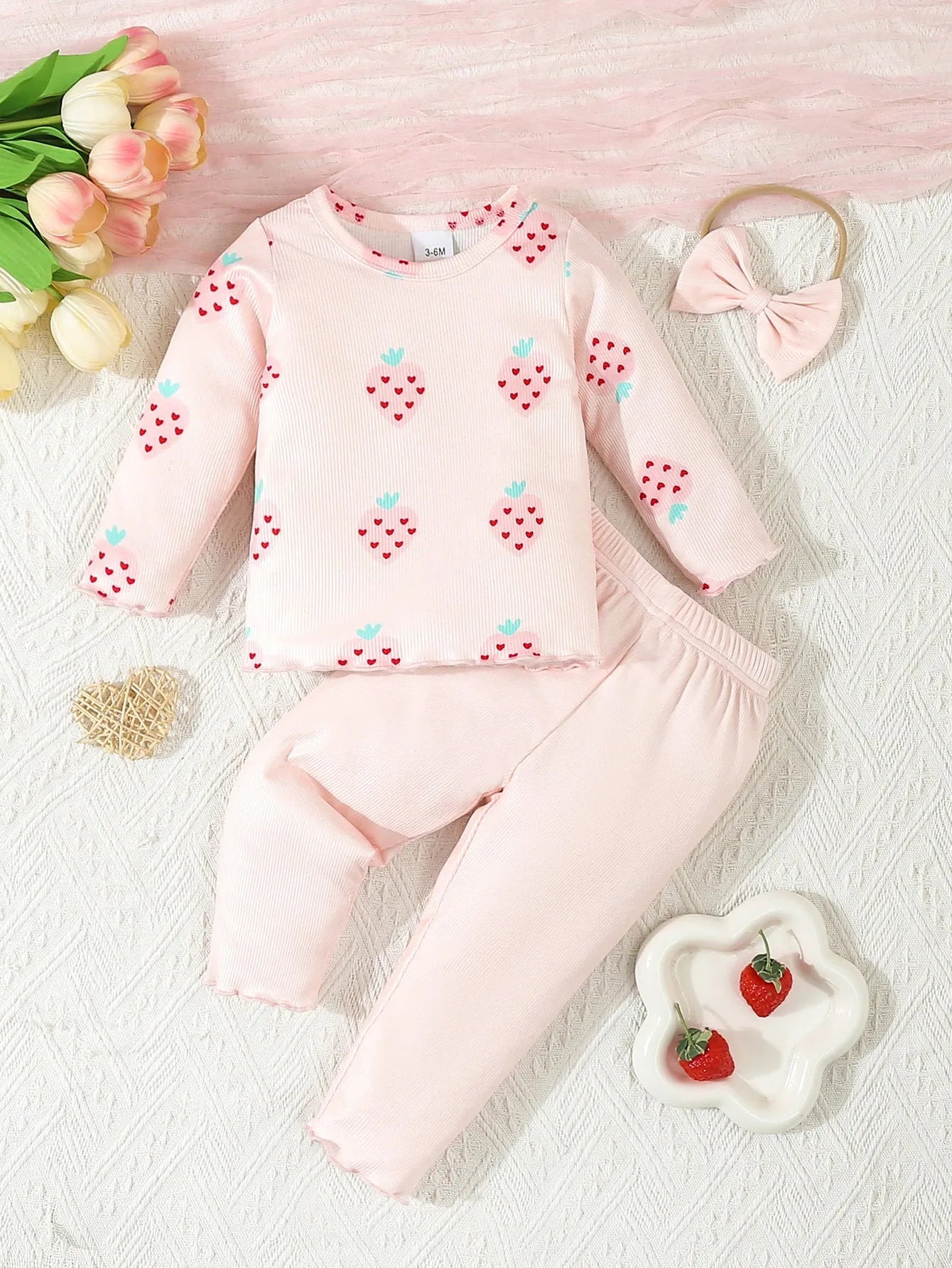 Infant wearing a light blue polyester 3-piece set with long sleeves, pants, and a matching hat.