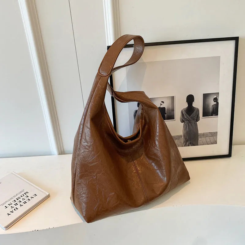 Soft PU leather large capacity shoulder bag in multiple colours with front sandwich pocket.