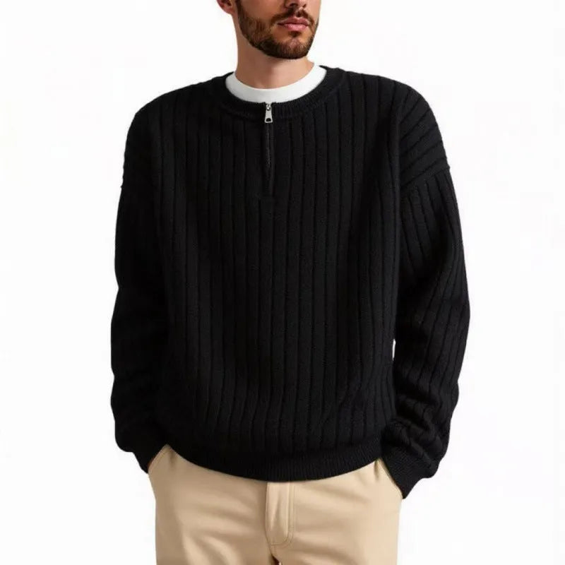A grey men's loose fit half zip sweater with a textured knit and long sleeves on a plain background.