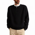 A grey men's loose fit half zip sweater with a textured knit and long sleeves on a plain background.