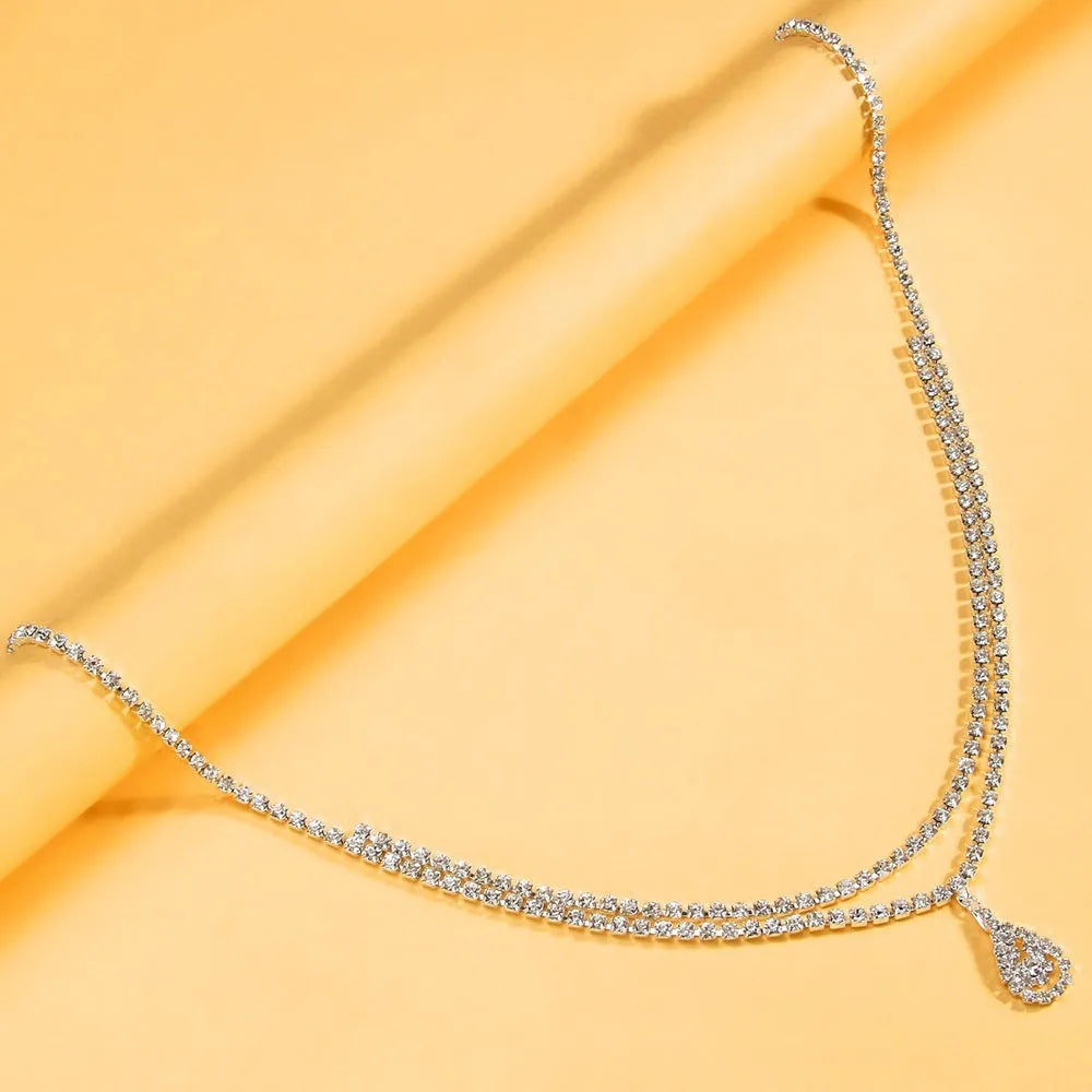 Gold and silver rhinestone waist chain for women with water drop pendant and lobster buckle.