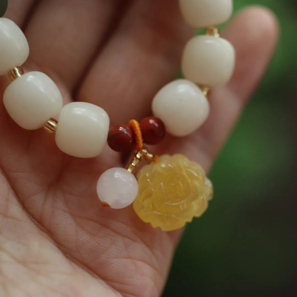 Bodhi root bracelet with gradient white jade and beeswax lotus pendants