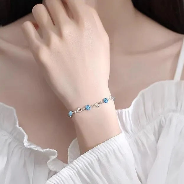 Blue diamond heart necklace and bracelet set with adjustable chain on copper background
