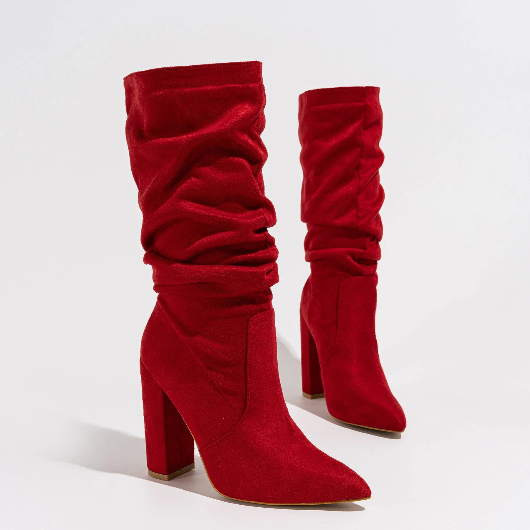 Women's black suede chunky heel pointed toe ankle boots with a high heel, shown from the side.