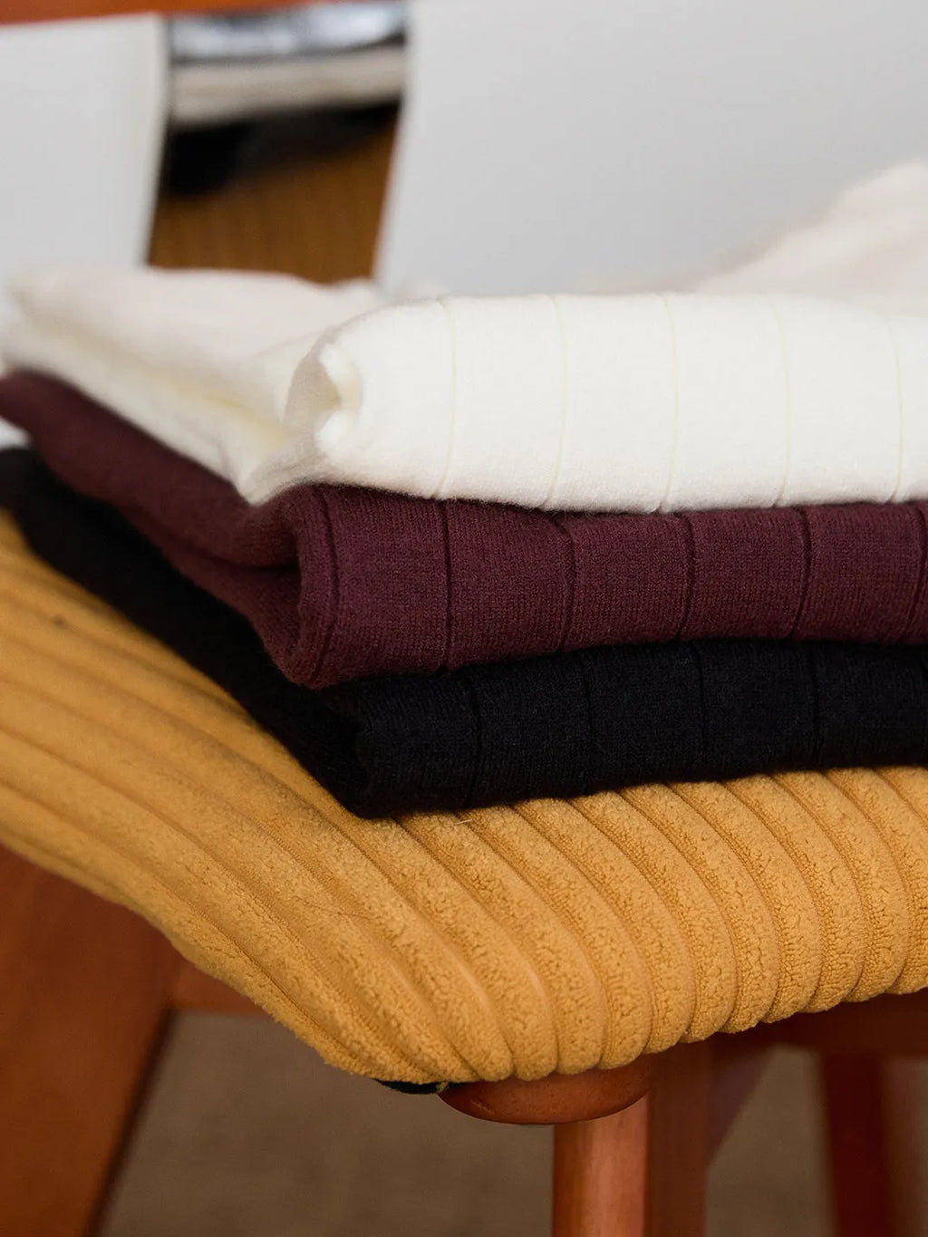 Half turtleneck wool blend knitted short sleeve T-shirt in chocolate colour, front view, on white background.