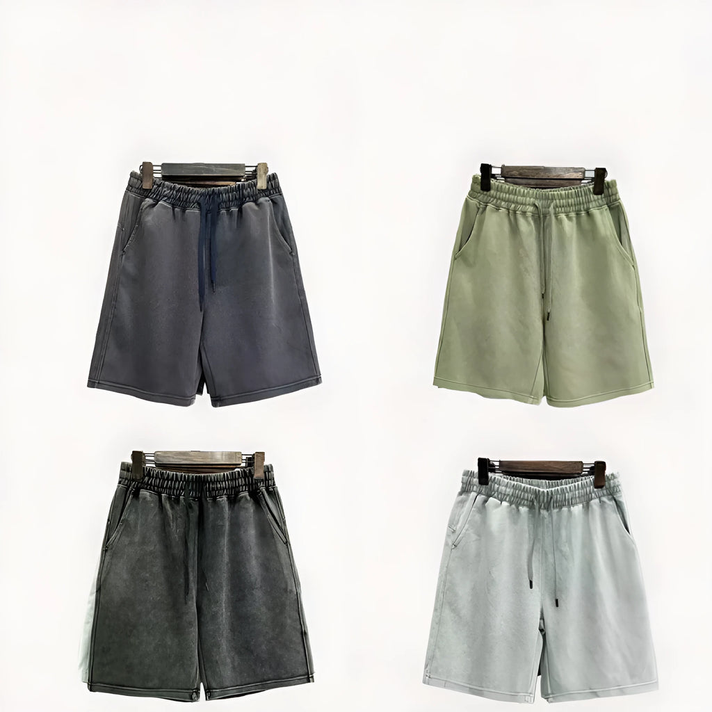Man wearing loose-fit, light blue cotton shorts with distressed detailing and a straight-leg cut.