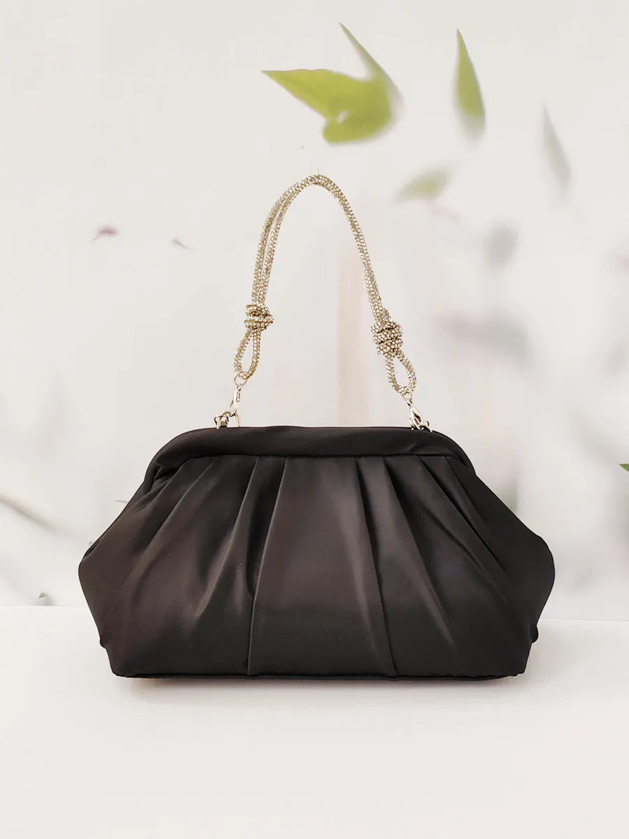 Soft lavender purple women's shoulder messenger bag with chain detail, shown in shell shape with folds.