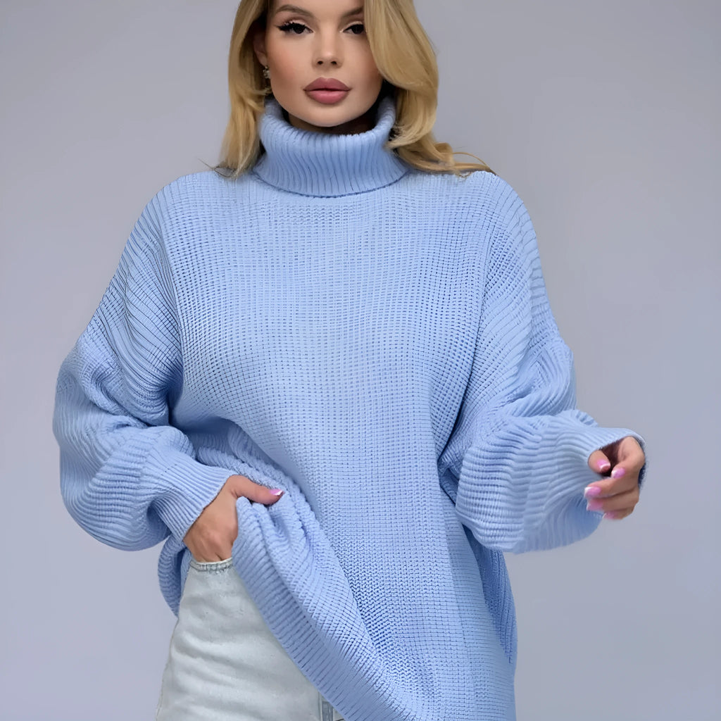 Woman wearing a thick high-neck pullover sweater in a solid colour with a textured 3D pattern.