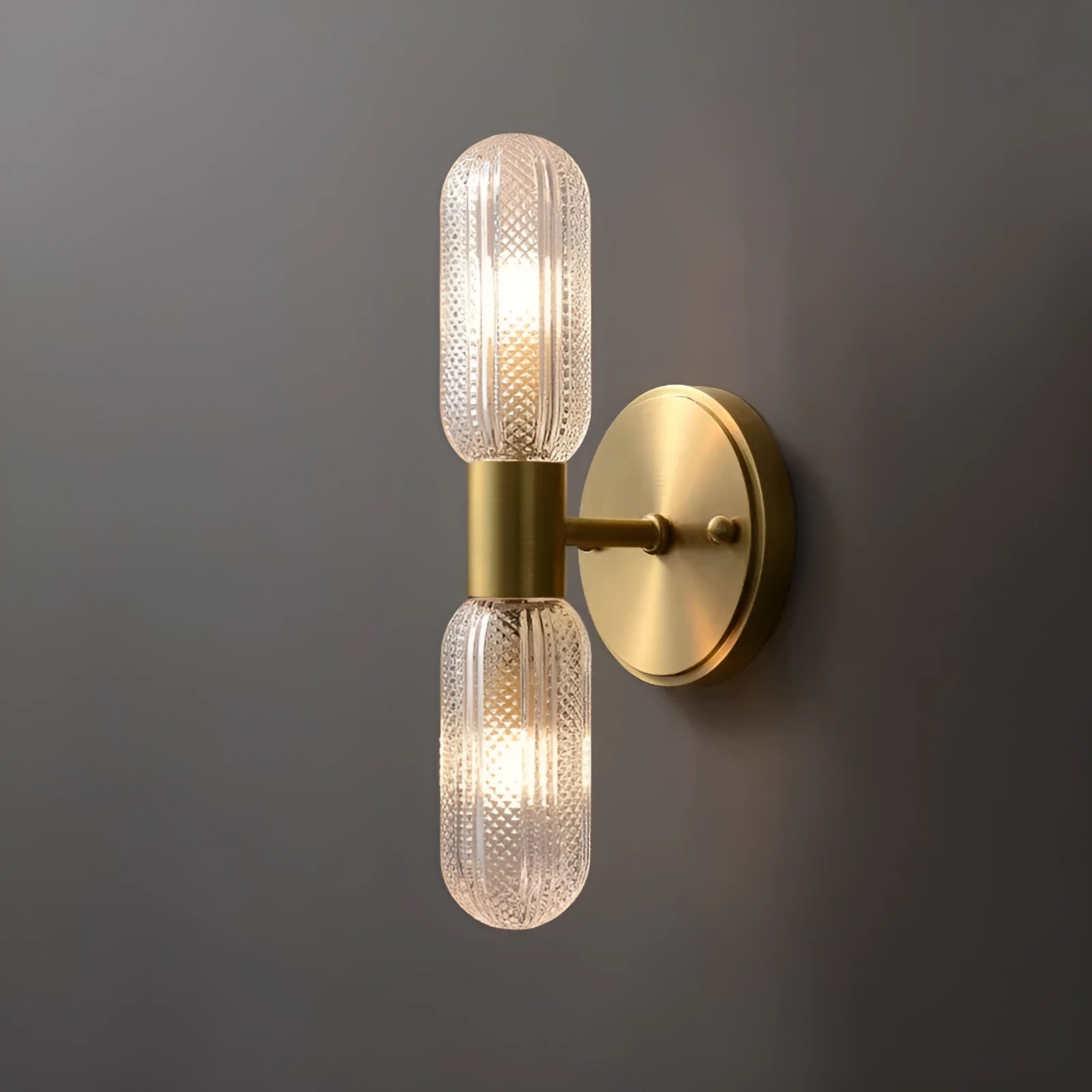 Modern double head wall lamp with a copper finish mounted on a light grey wall.