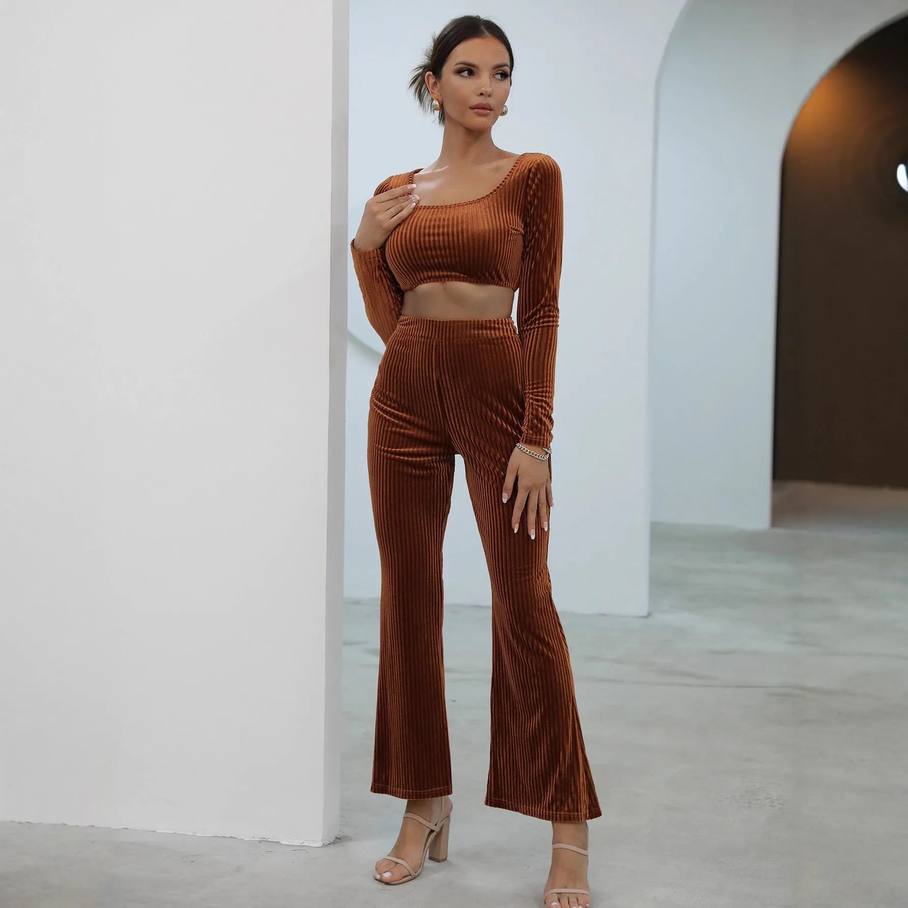 Caramel coloured women's long sleeve sweater and matching straight-leg trousers set on a hanger.