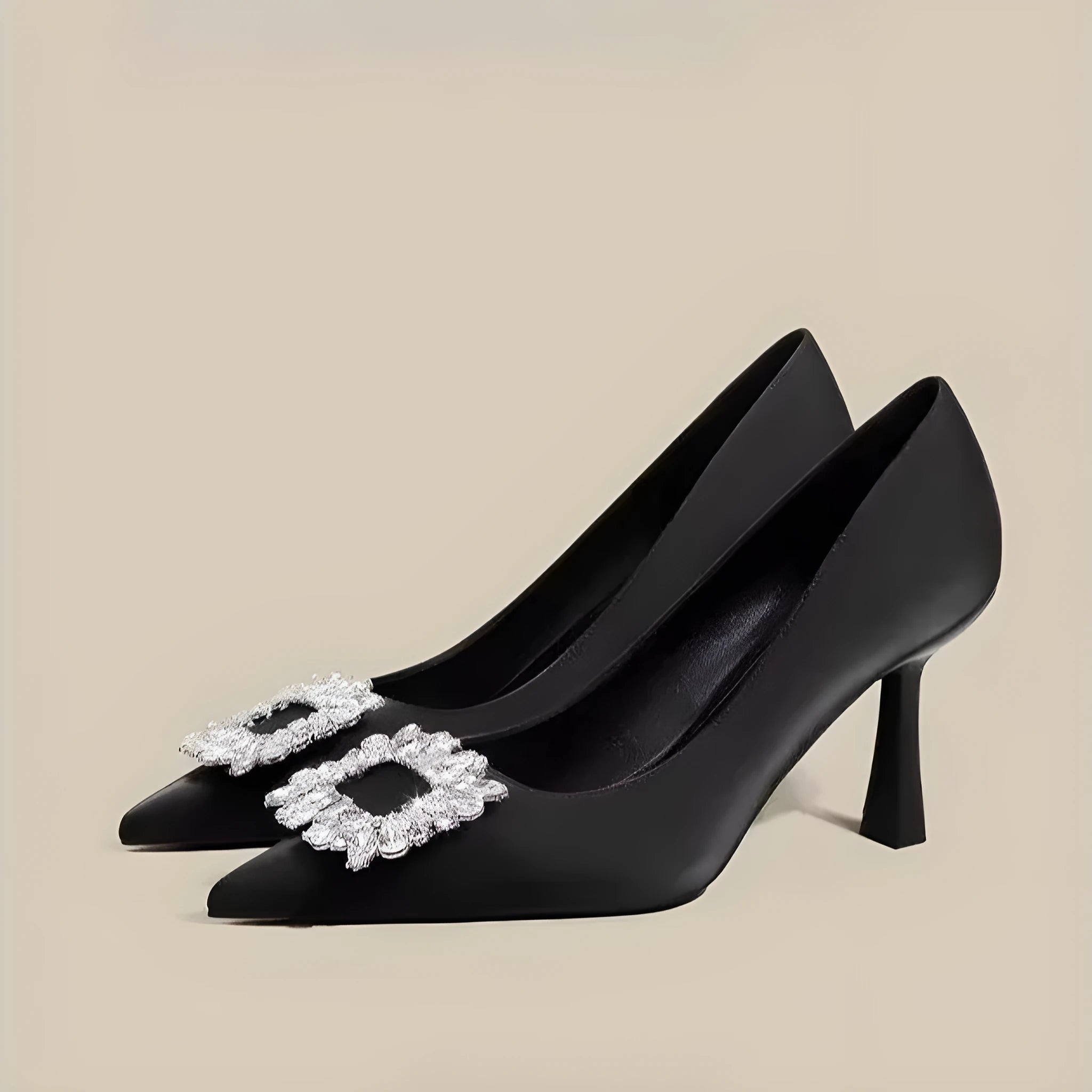 Women's creamy-white pointed toe stiletto high heels with a mid-height heel on a plain background.