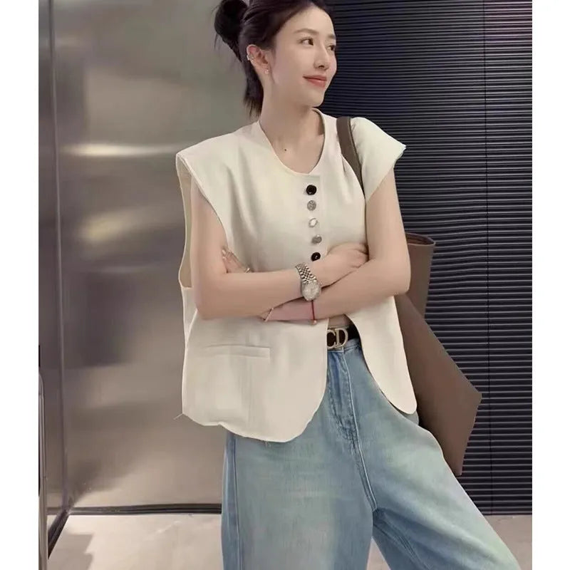 Women's loose fit polyester vest in milky white with pockets, shown on a hanger.