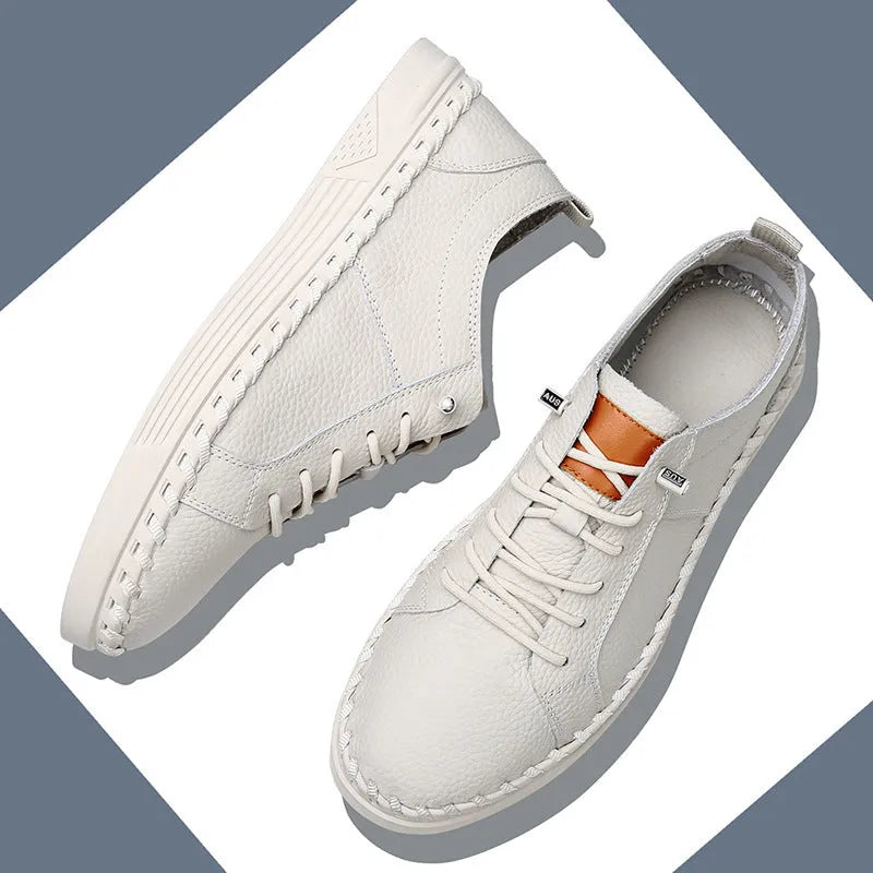 Men's beige and black cowhide leather sneakers with round toe and visible stitching on a white background.