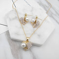 Gold heart pearl jewellery set with alloy necklace and earrings on display