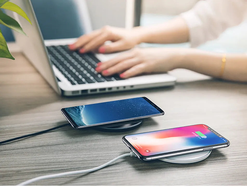 Black glass disc wireless charger with LED indicator light on smooth surface