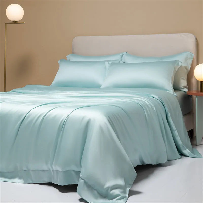 A neatly made bed with a Lenzing Tencel duvet cover and pillowcases in a soft grey colour.