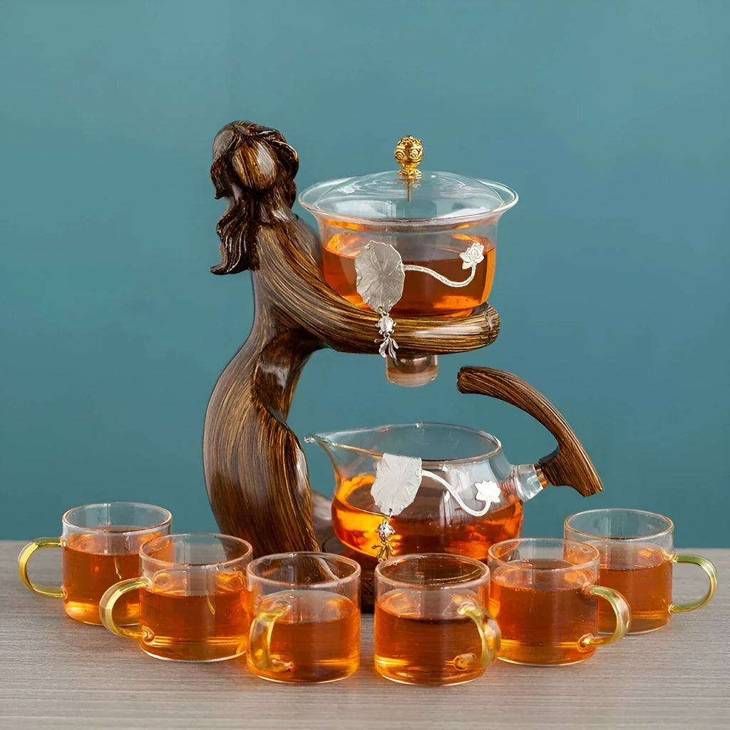 Maid semi-automatic glass teapot set with heat-resistant base and stainless steel tea infuser on a tea tray