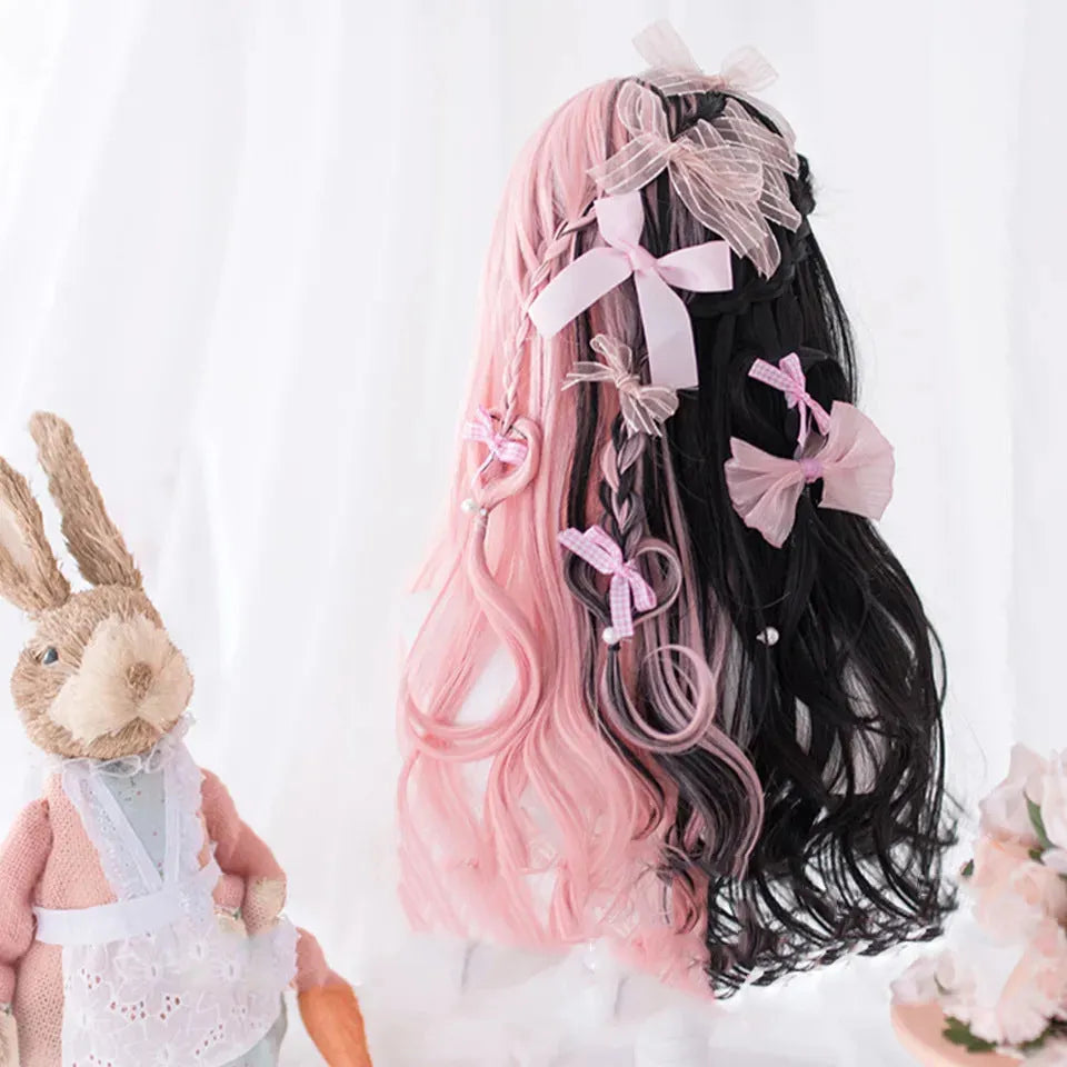 Long curly black and pink Lolita cosplay wig with a fringe on a display head.