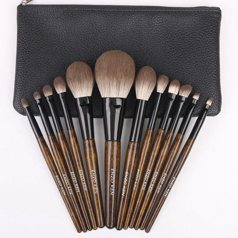 12-piece makeup brush set with wooden handles and a black PU travel case open to show brushes.
