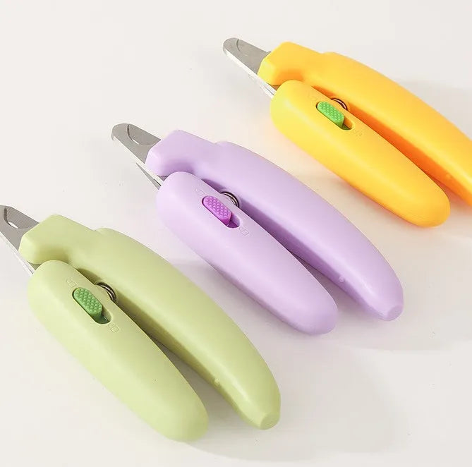 Banana-shaped pet nail clippers in green with metal blades for dog and cat grooming