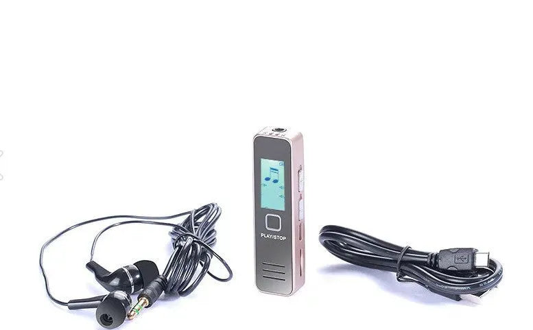 Small black or gold portable digital voice recorder with USB cable on a desk.