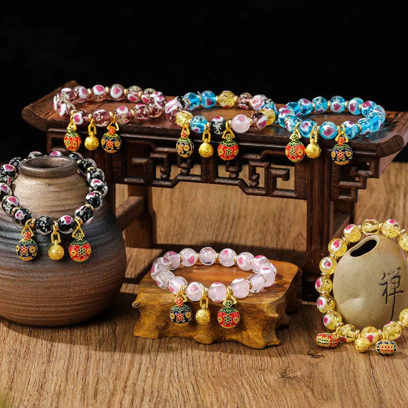 Handmade glass bracelet with swallowing gold beast charm and heart-shaped fluorescent glaze beads