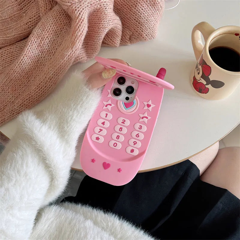 Light pink silicone flip phone case with built-in mirror for iPhone on a table