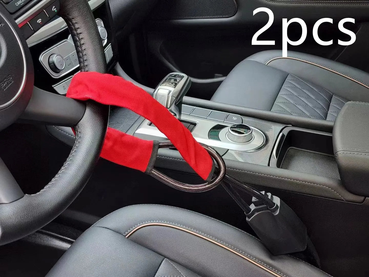 Red iron car steering wheel lock with brass core for General Motors vehicles on a steering wheel.