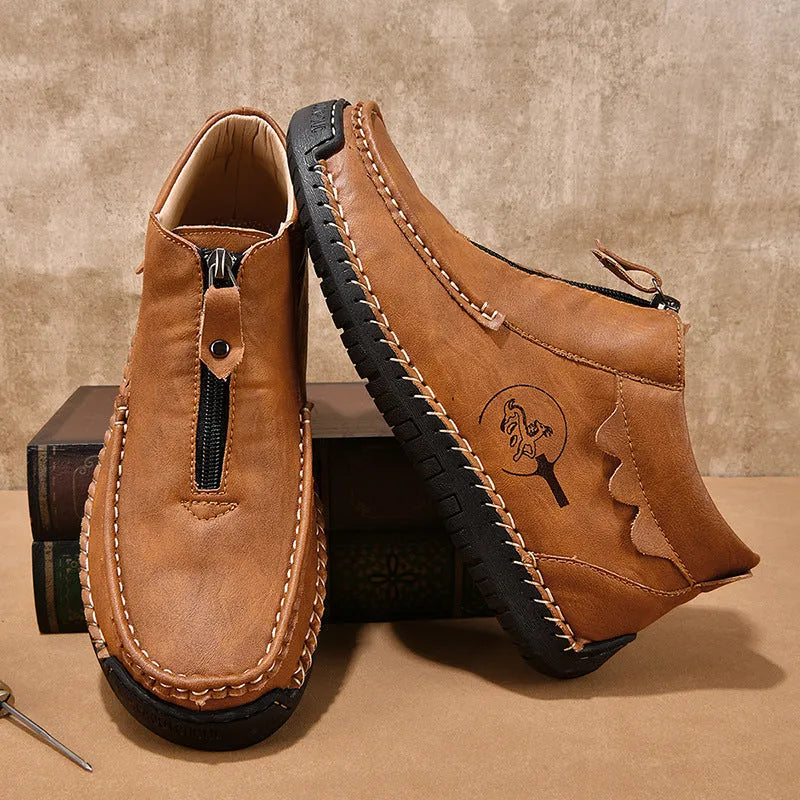 Men's black slip-on loafers with a round toe and low rubber sole.